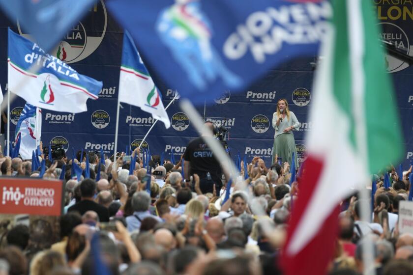 FILE - Right-wing party Brothers of Italy's leader Giorgia Meloni, center-right on stage, addresses a rally as she starts her political campaign ahead of Sept. 25 general elections, in Ancona, Italy, Tuesday, Aug. 23, 2022. The Brothers of Italy party has won the most votes in Italy’s national election. The party has its roots in the post-World War II neo-fascist Italian Social Movement. Giorgia Meloni has taken Brothers of Italy from a fringe far-right group to Italy’s biggest party. (AP Photo/Domenico Stinellis, File)
