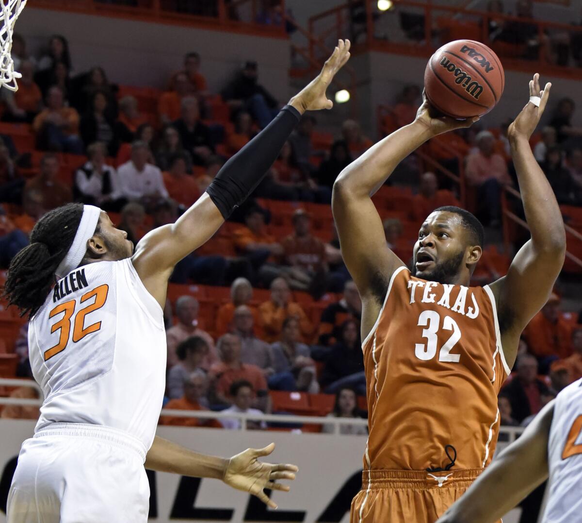 Texas forward Shaquille Cleare takes a shot over Oklahoma State center Anthony Allen Jr. during the second half of a game on March 4.