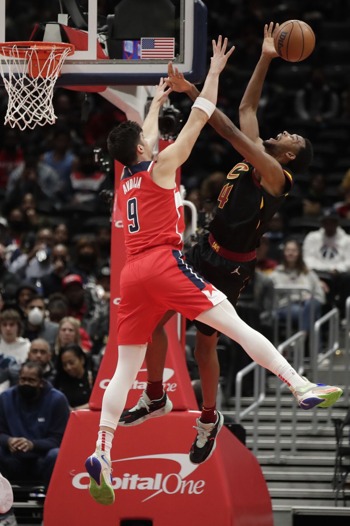Cleveland Cavaliers' Evan Mobley, right, attempts to shoot as Washington Wizards' Deni Avdija (9) defends during the first half of an NBA basketball game, Friday, Dec. 3, 2021, in Washington. (AP Photo/Luis M. Alvarez)