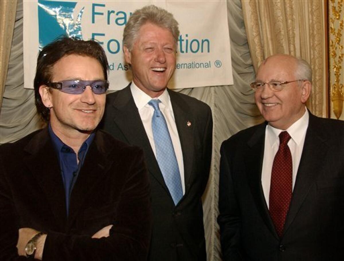 FILE - This is a Sunday, March 10, 2002 file photo of Former President Clinton, center, shares a laugh with Former President of the Russian Federation Mikhail Gorbachev, right, and Bono, left, of the rock group U2, before a dinner hosted by Mr. Gorbachev, at the Russian Embassy in New York in honor of the Frank Foundation Child Assistance International of Washington D.C. (AP Photo/Stephen Chernin, Pool, File)