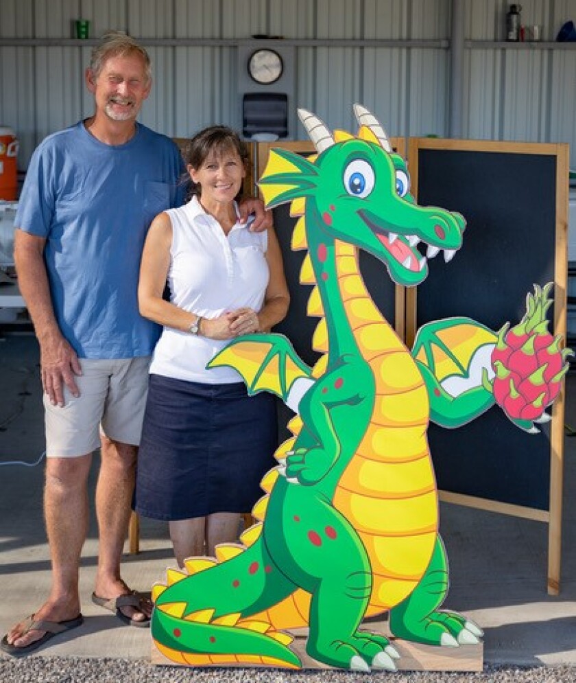 Kevin and Betsy Brixey hang out with the local dragon at their ranch in Ramona.