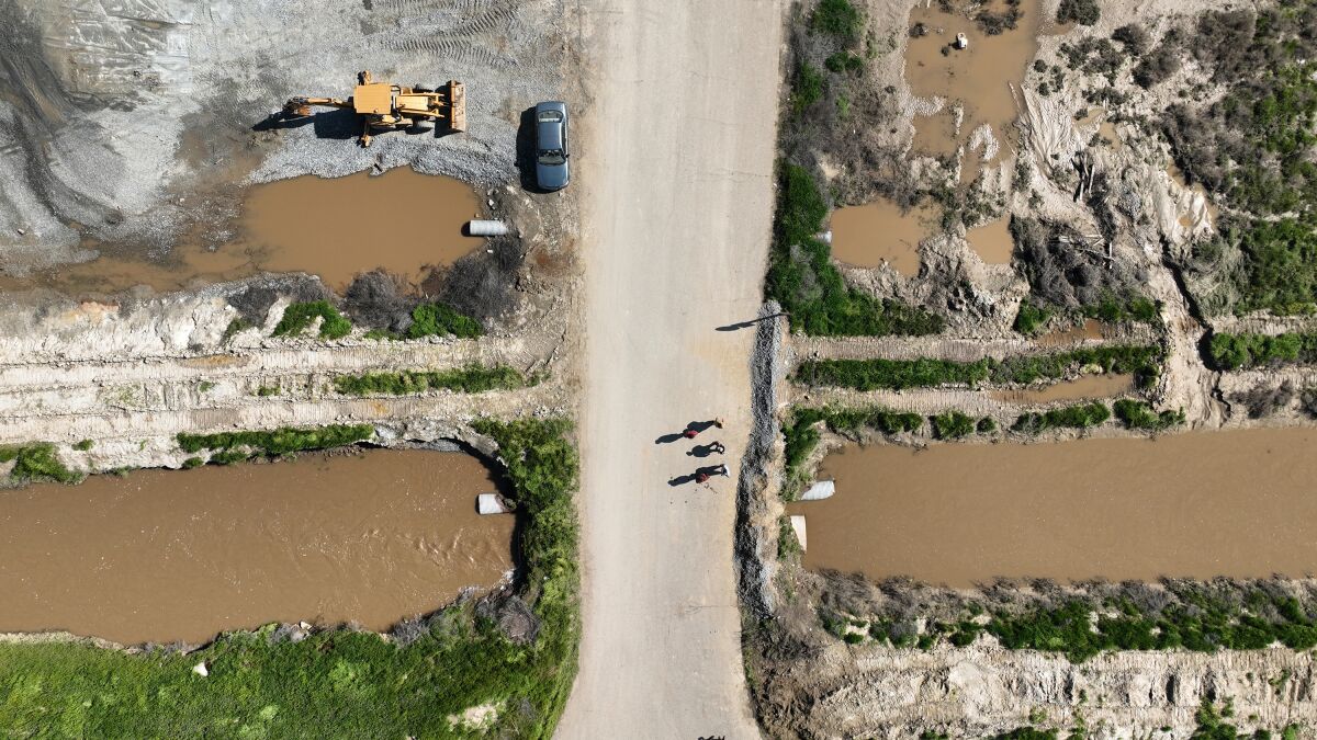 An aerial view of people walking on a levee