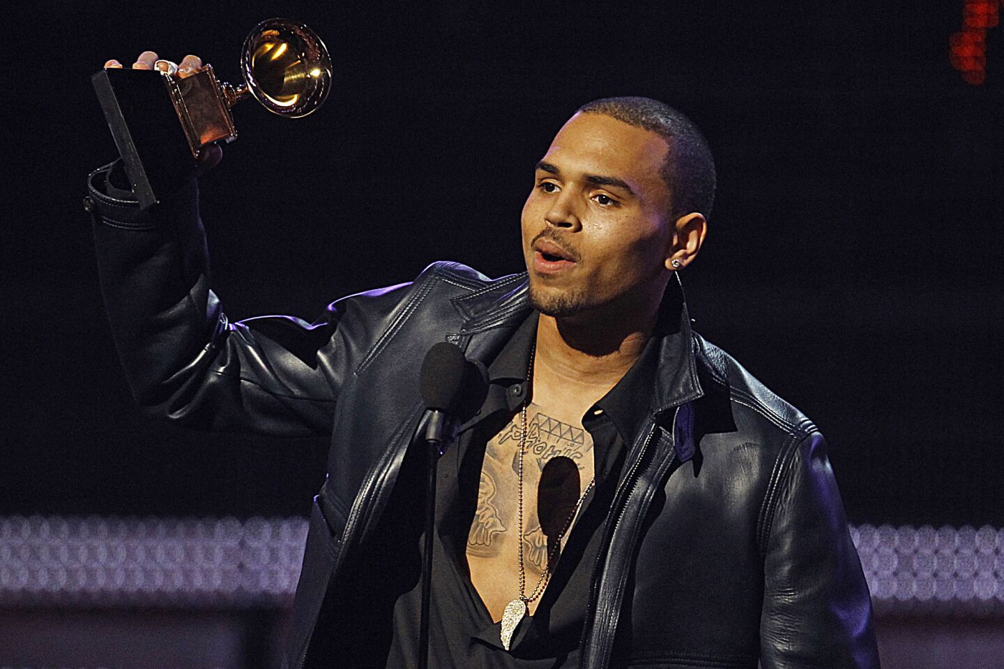 Three years after he was arrested for assaulting his girlfriend Rihanna after a pre-Grammys party, Chris Brown received his first Grammy award when his album "F.A.M.E." won best R&B album. Brown said nothing about his past deeds as he accepted the award on the telecast.
