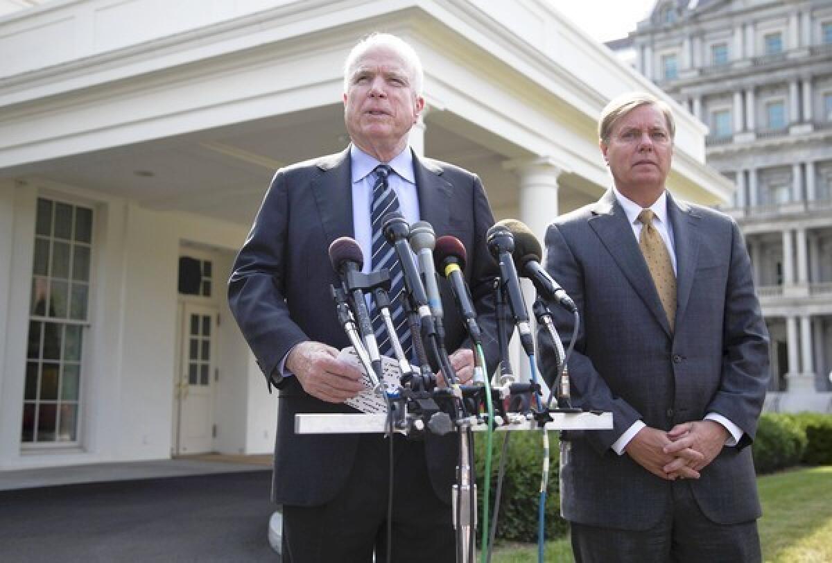 Sens. John McCain (R-Ariz.), left, and Lindsey Graham (R-S.C.) speak with reporters outside the White House. The two Republican hawks may prove pivotal to President Obama's efforts to secure congressional approval for airstrikes in Syria.