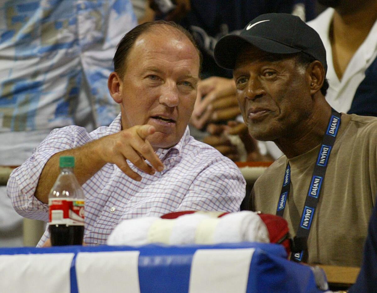 Clippers coach Mike Dunleavy Sr. and executive Elgin Baylor chat during a summer league game in 2003.