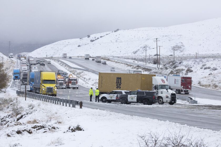 GORMAN, CA - DECEMBER 30: Traffic is turned around on the northbound 5 Freeway just before Gorman on Thursday, Dec. 30, 2021 as a passing cold storm brought snow to parts of the southland closing the 5 Freeway through the Grapevine. (Myung J. Chun / Los Angeles Times)