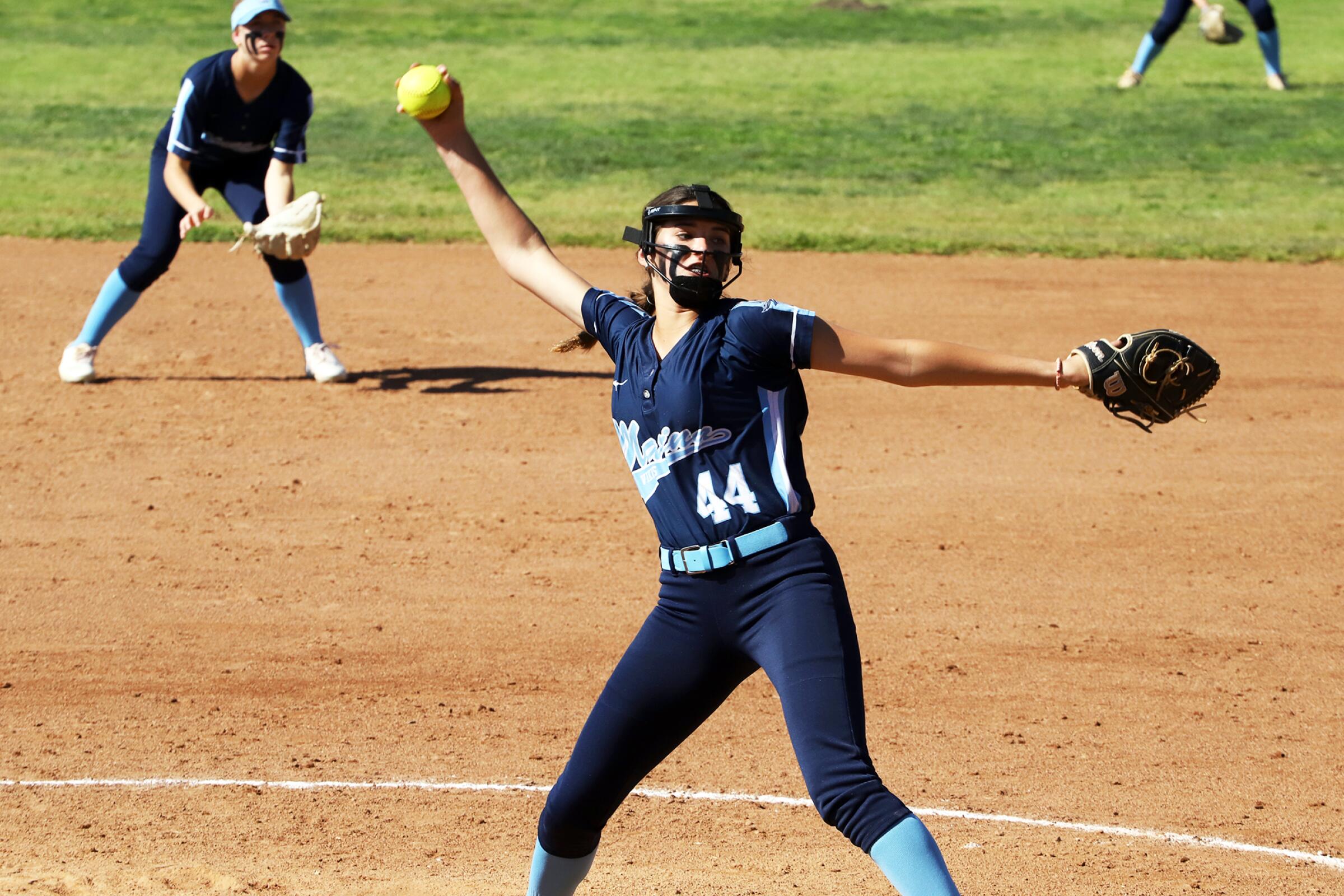 Marina High School's Mia Valbuena pitches against Saint Francis High School's girls' softball team.