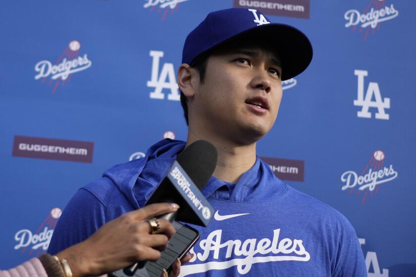 Dodgers star Shohei Ohtani speaks to reporters at Camelback Ranch on Friday.