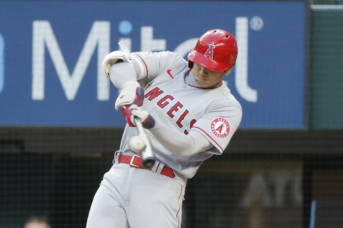 Los Angeles Angels' Shohei Ohtani hits a solo home run against the Texas Rangers during the first inning of a baseball game, Friday, April 15, 2022, in Arlington, Texas. (AP Photo/Michael Ainsworth)