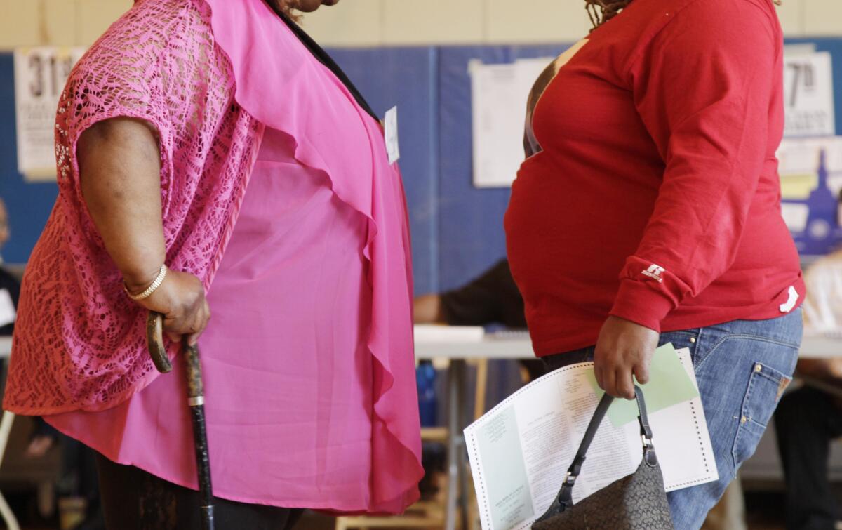 Two obese women talk in New York.