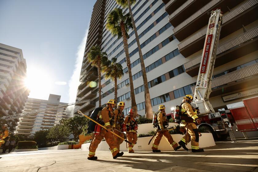 LOS ANGELES CA JANUARY 29, 2020 -- Los Angeles Firefighters on Wednesday battled a large blaze that has enveloped the sixth floor of the 25-story Barrington Plaza apartments in Los Angeles, forcing residents to evacuate from the structure. (Al Seib / Los Angeles Times)