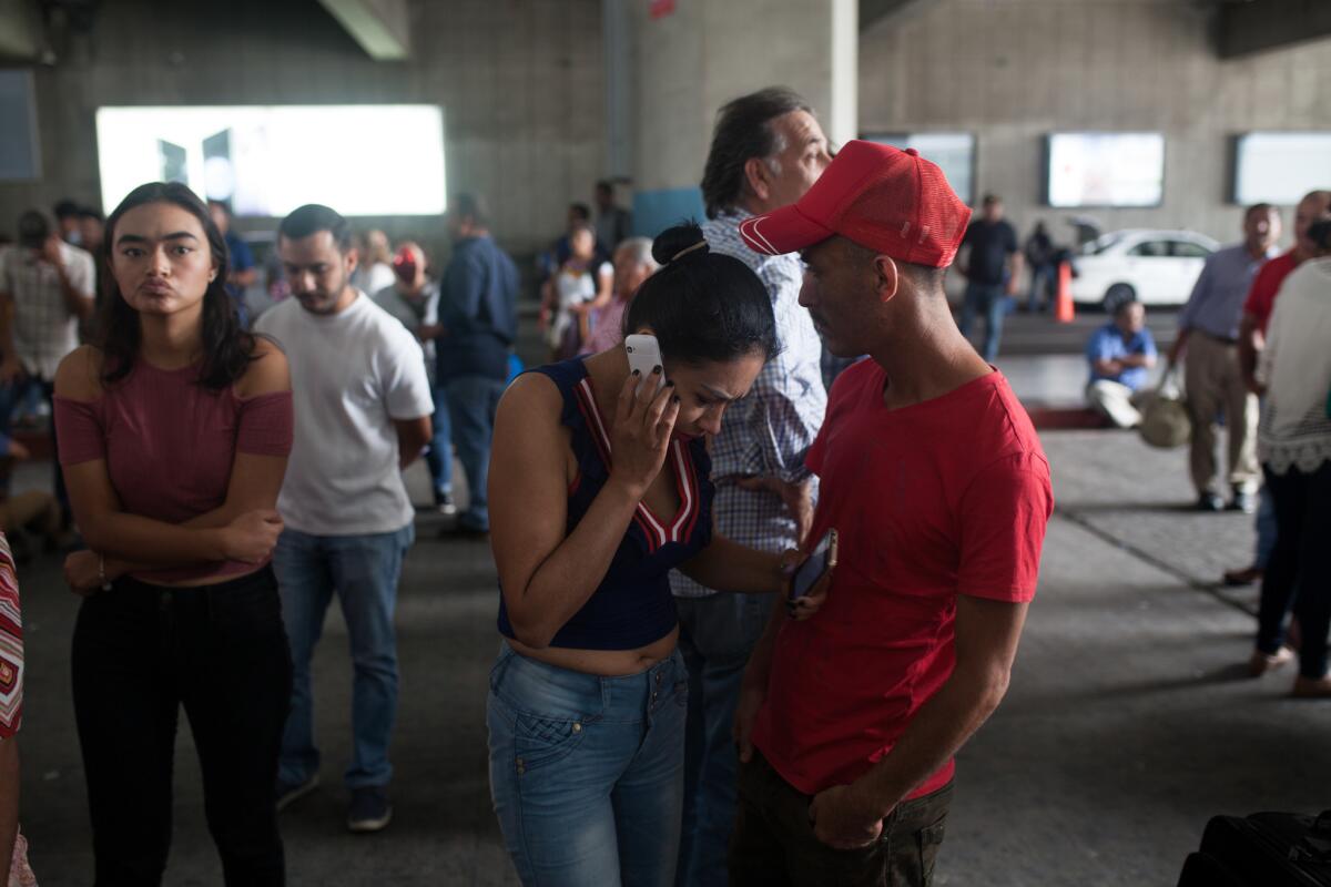 Erik's mother, Nuria Lanuza, and father, Erik Castillo, receive a call telling them that they must retrieve their child at a government center in downtown Guatemala City, rather than at the airport.