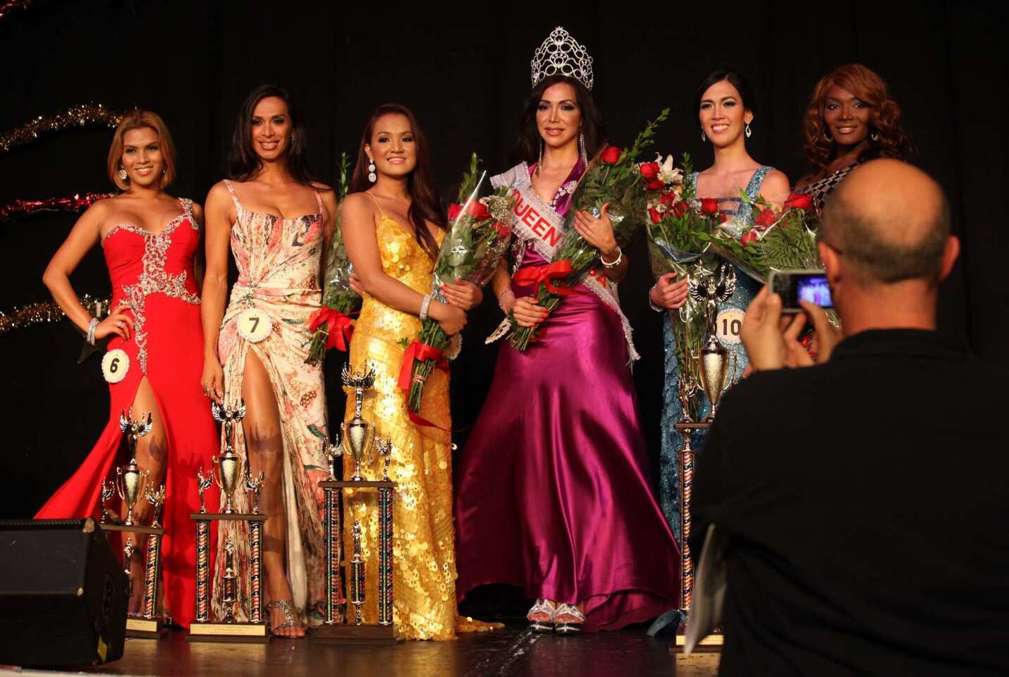 From left, Miss New York, Miss Oklahoma, Miss Wyoming, Miss West Virginia, Miss Tennessee and Miss California pose for the cameras after the Miss Queen USA pageant at the Circus Disco in Los Angeles on Sunday night. Queen USA calls itself "the premier transgender beauty pageant in the United States."