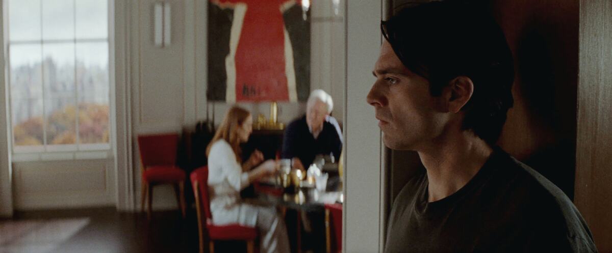 Julianne Moore, left, John Lithgow and Sebastian Stan in the movie "Sharper."