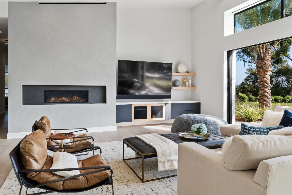 A modern, spacious living room with soft, neutral colors.