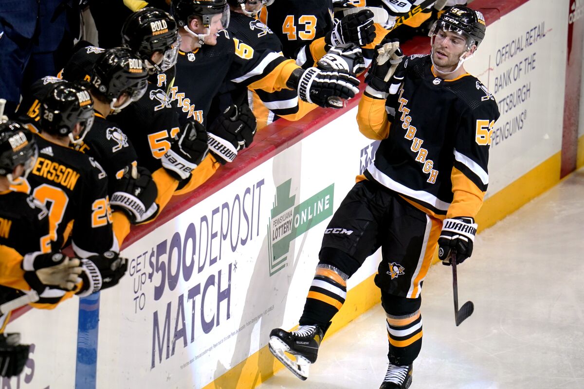 Pittsburgh Penguins' Mark Friedman (52) returns to the bench after scoring during the third period of an NHL hockey game against the Vegas Golden Knights in Pittsburgh, Friday, March 11, 2022. (AP Photo/Gene J. Puskar)