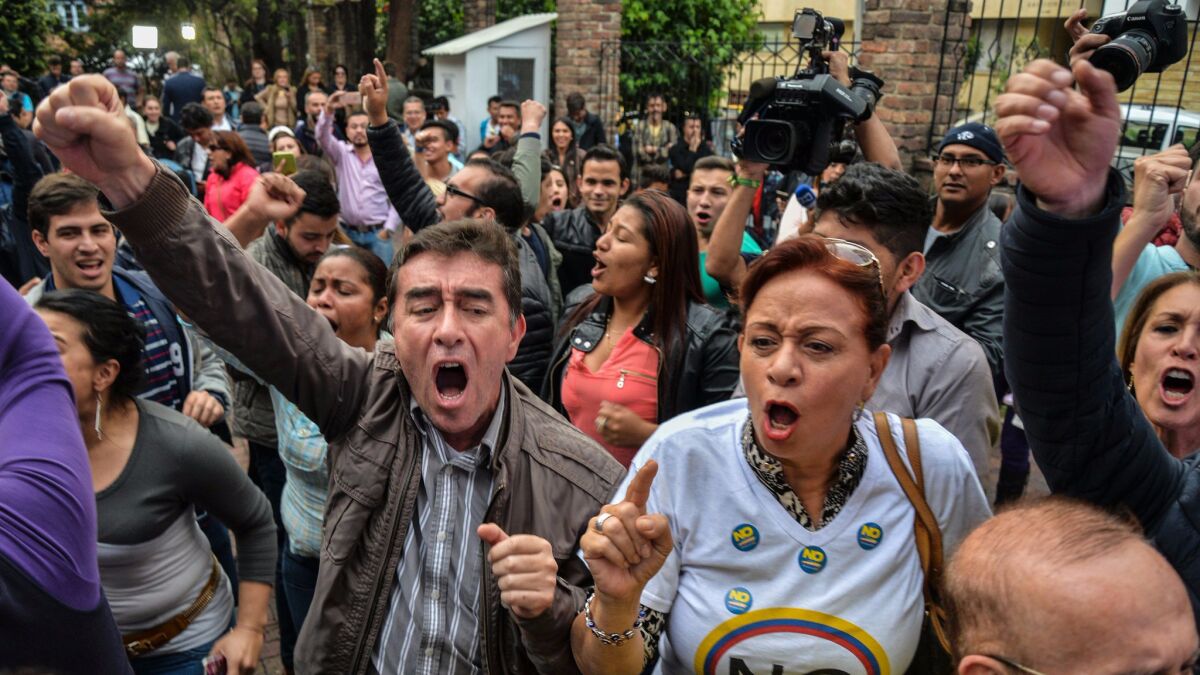 Colombian voters celebrate the results of a referendum on whether to ratify a historic peace accord to end a 52-year war between the state and the communist FARC rebels, in Bogota on Oct. 2, 2016.