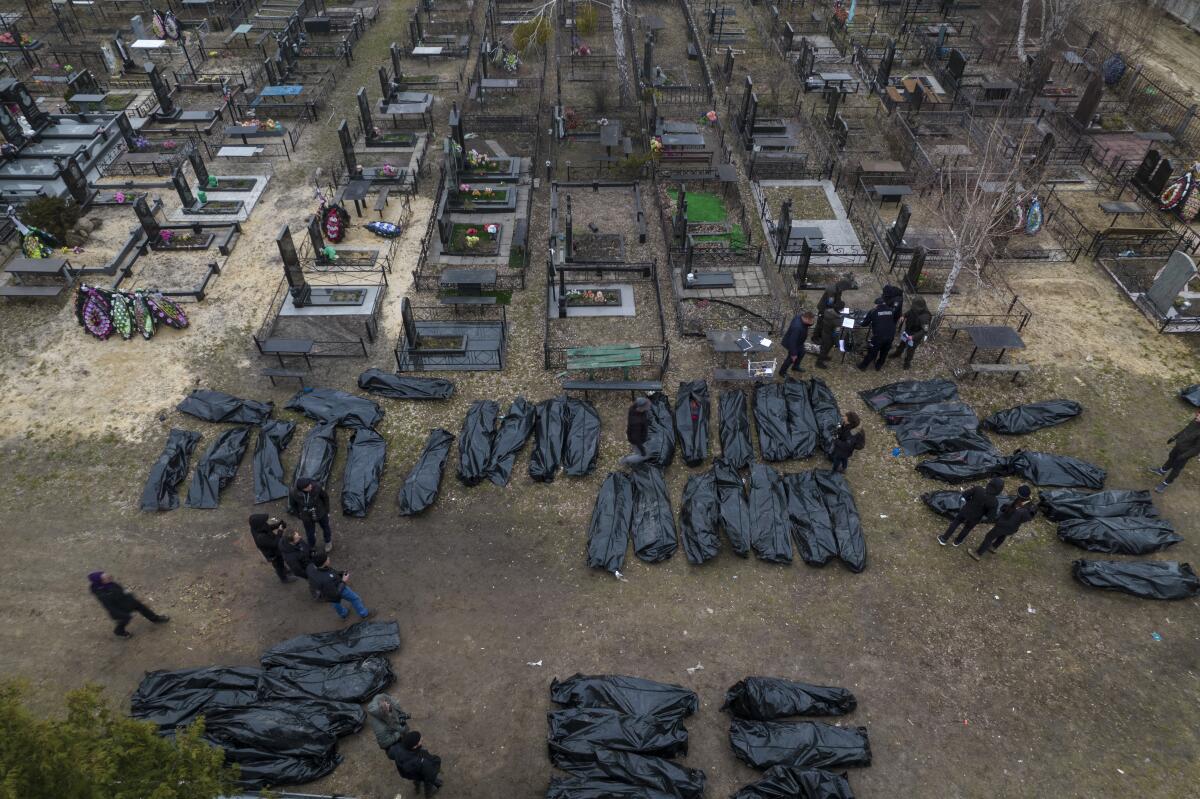 Dozens of civilians in body bags await burial in Bucha, Ukraine, on April 6. 