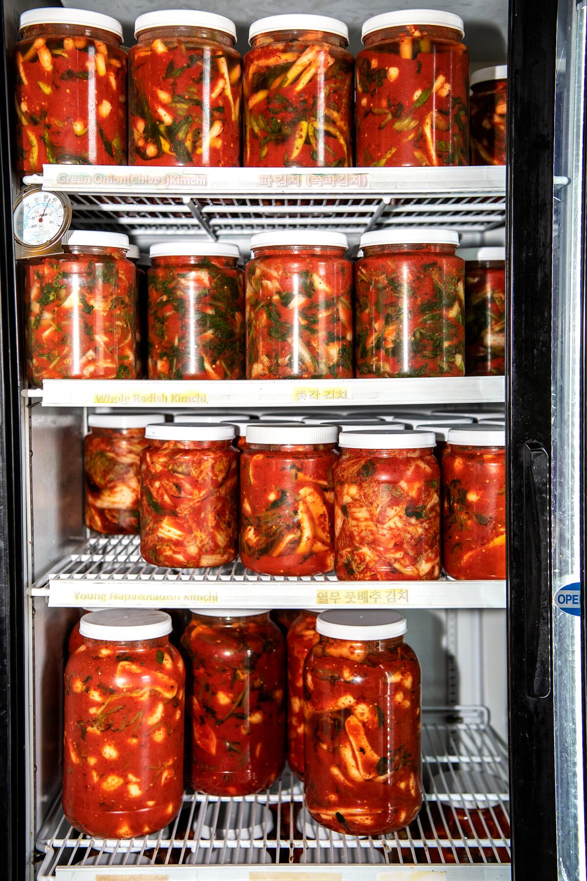 Jars of kimchi in a refrigerator