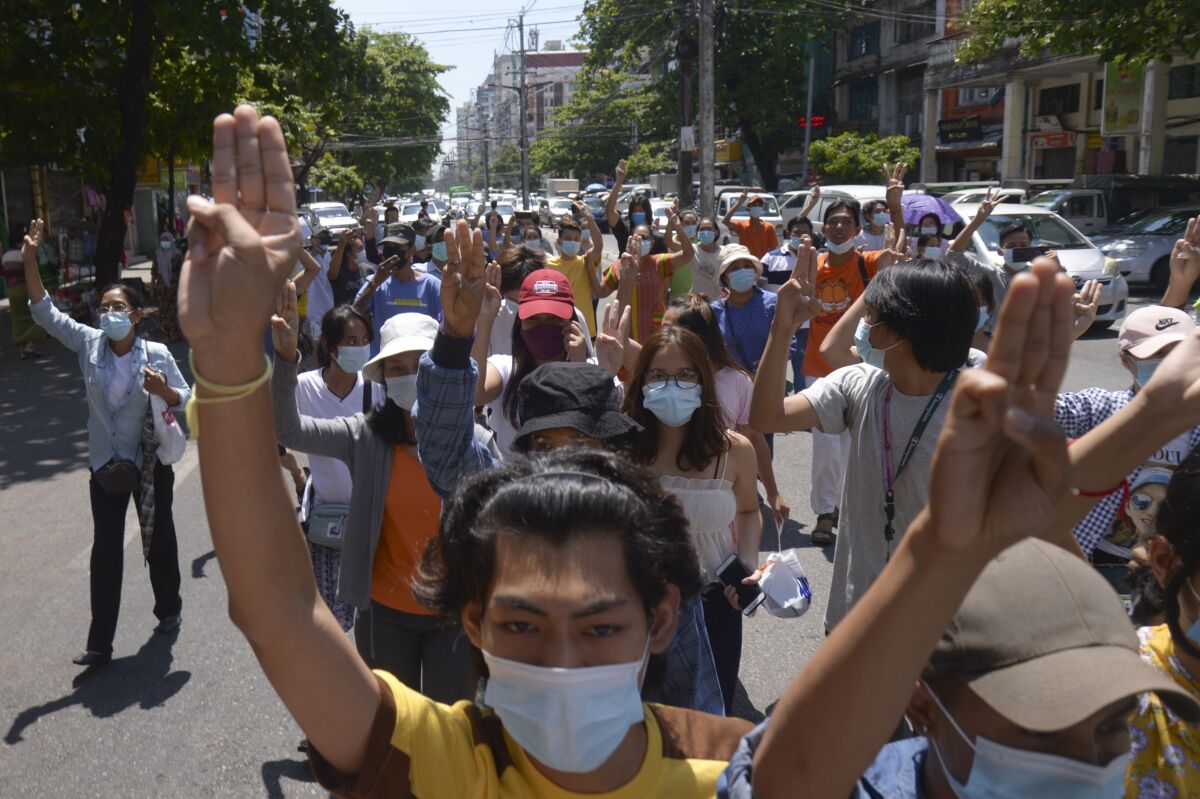 Anti-coup protesters flash the three-finger salute during a rally in Yangon, Myanmar on Tuesday May 4, 2021. The ruling junta continues to face a challenge in the cities and towns of Myanmar, where street protests are still being held more than three months after it seized power.(AP Photo)