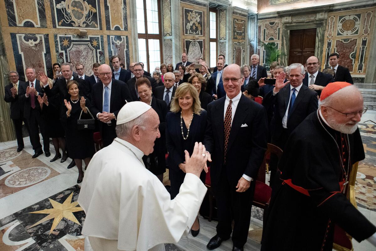 Pope Francis meets with a group of people in an ornate room