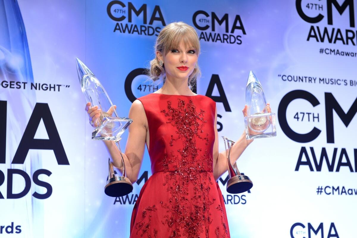 Pinnacle Award winner Taylor Swift poses at the CMA Awards.