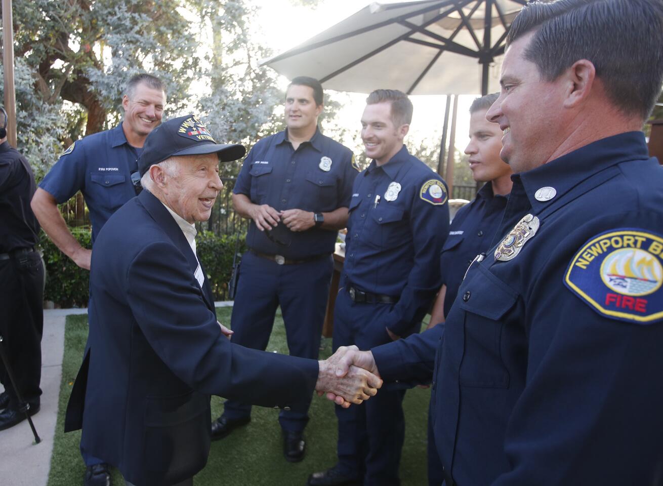 Tom Evans, a past skipper of the Newport Beach Chamber of Commerce Commodores Club, greets members of the city Fire Department at the 21st annual Newport Beach Fire and Lifeguard Appreciation Dinner on Thursday at the Newport Beach Marriott Hotel & Spa.