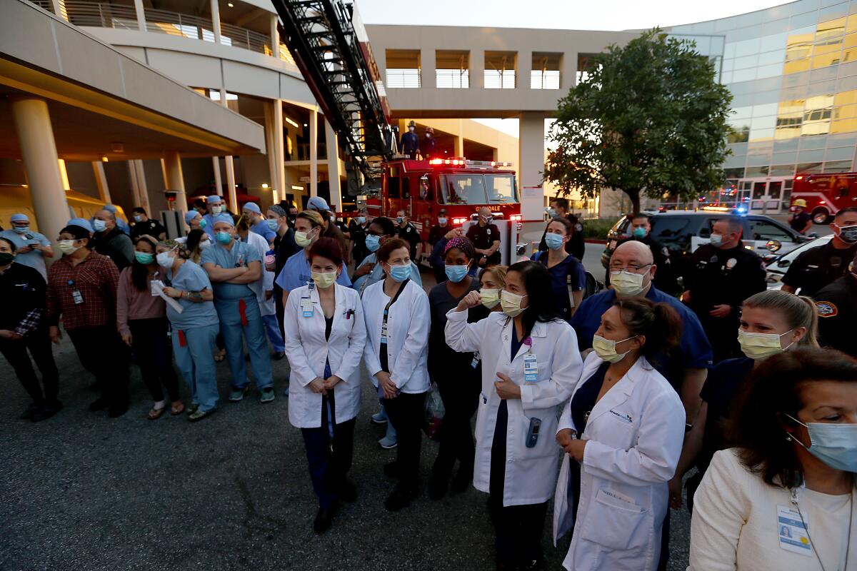 Healthcare workers, police and firefighters gather for a tribute to the fight against the coronavirus at Glendale Adventist Hospital.