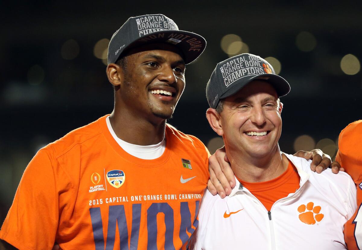 Clemson quarterback Deshaun Watson stands with Coach Dabo Swinney after the Tigers defeated the Oklahoma Sooners in the 2015 Capital One Orange Bowl.