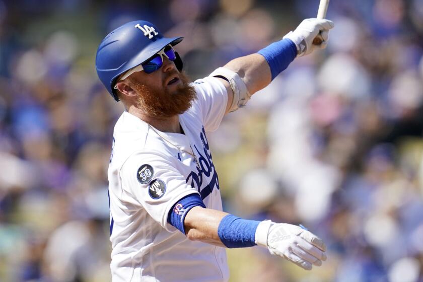 Los Angeles Dodgers' Justin Turner hits during a baseball game against the Colorado Rockies.