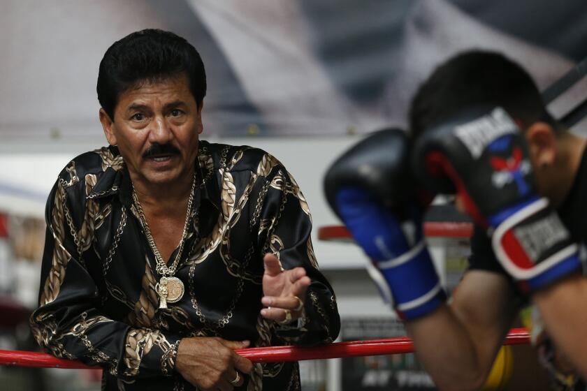 Jose Santa Cruz works with son Leo during a training session last year at Who's Next Boxing Club in La Puente.