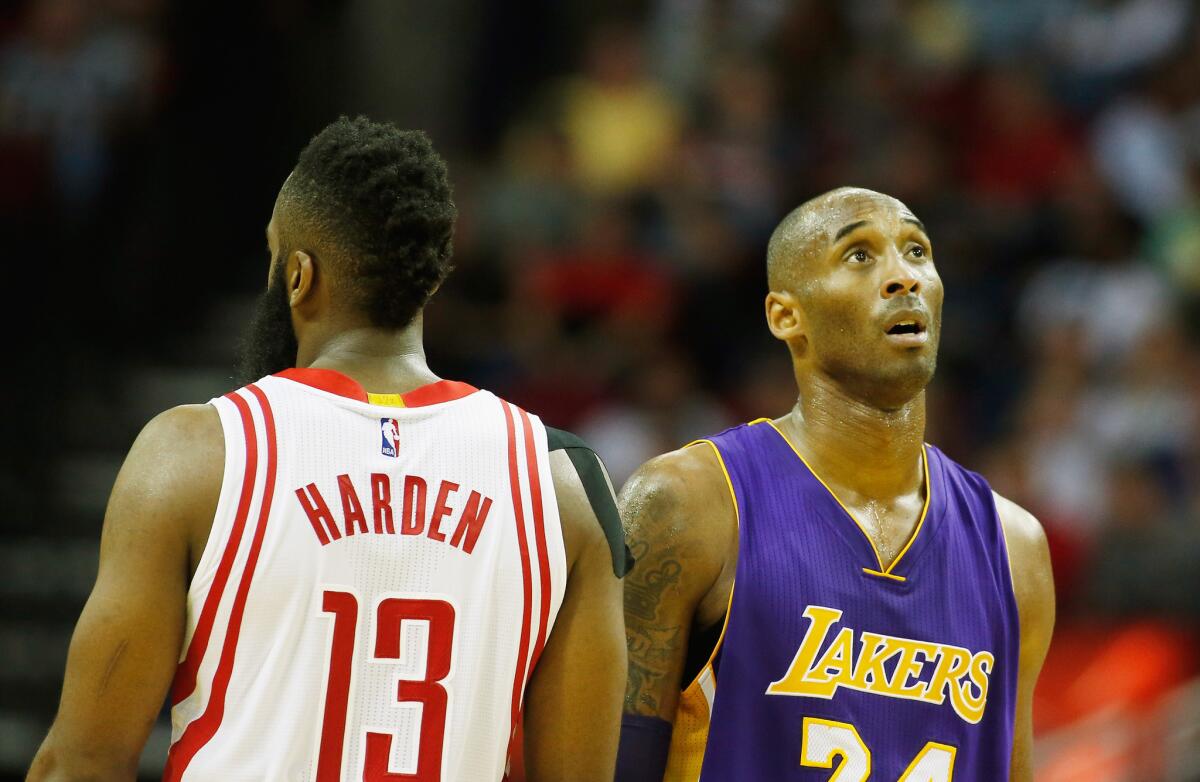 Rockets guard James Harden and Kobe Bryant cross paths on the court during a game Saturday at Toyota Center in Houston.