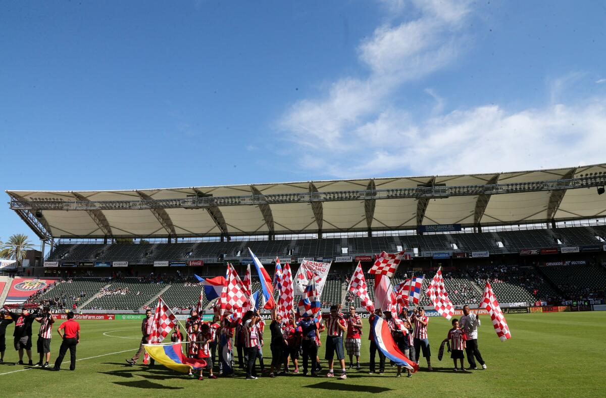 Members of a Chivas USA fan section cheer on the field at StubHub Center before a game in October against the San Jose Earthquakes.