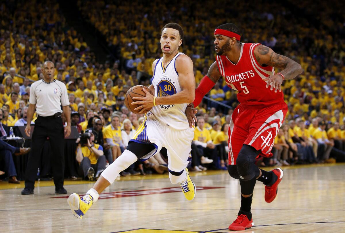 Warriors point guard Stephen Curry drives to the basket against Rockets forward Josh Smith during the fourth quarter.