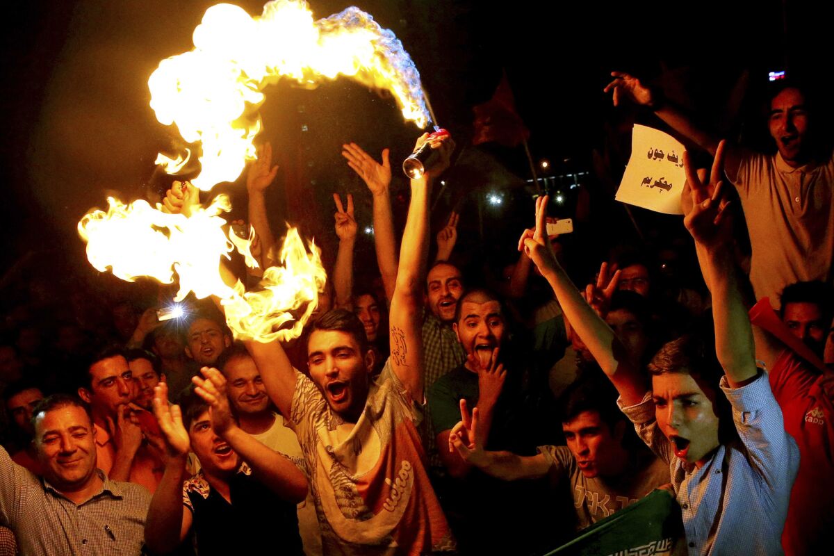 Iranians celebrate in Tehran after the landmark nuclear deal was announced July 14.