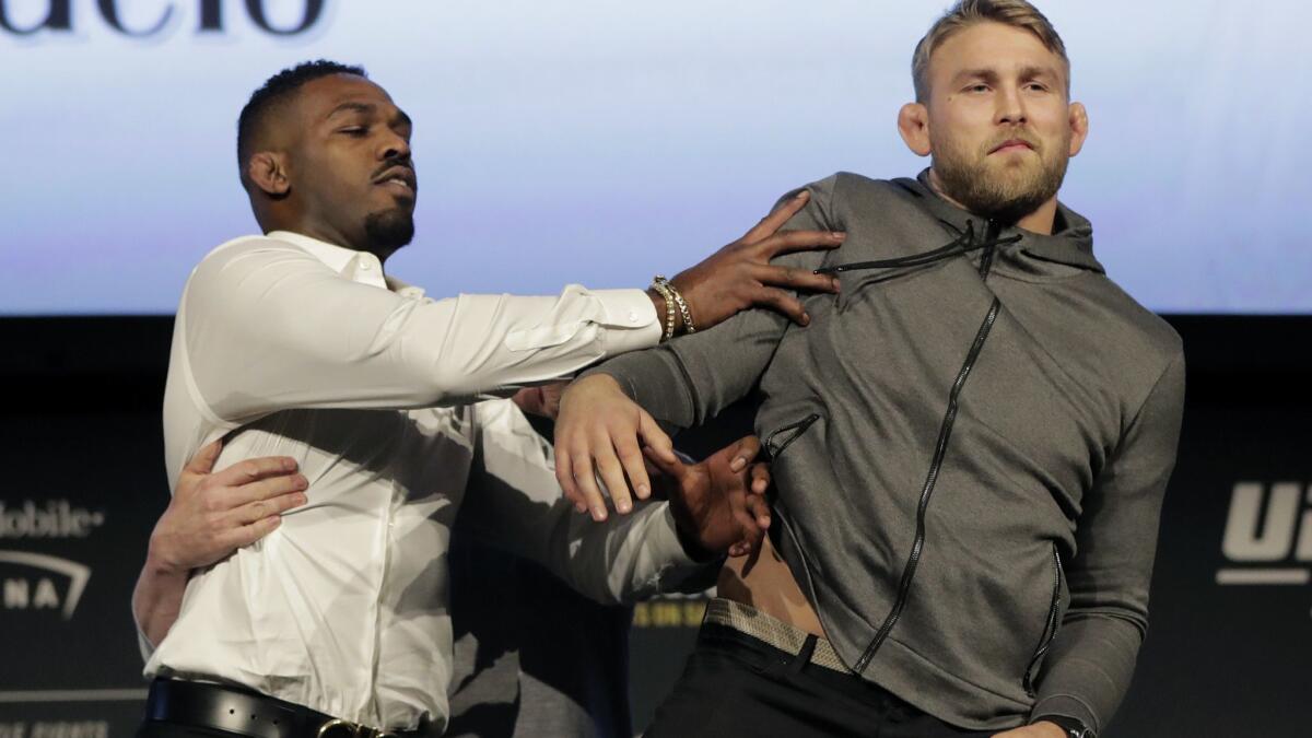 Jon Jones, left, pushes Alexander Gustafsson out of the way during a news conference Friday. The two are scheduled to meet in UFC 232 on Dec. 29 in Las Vegas.