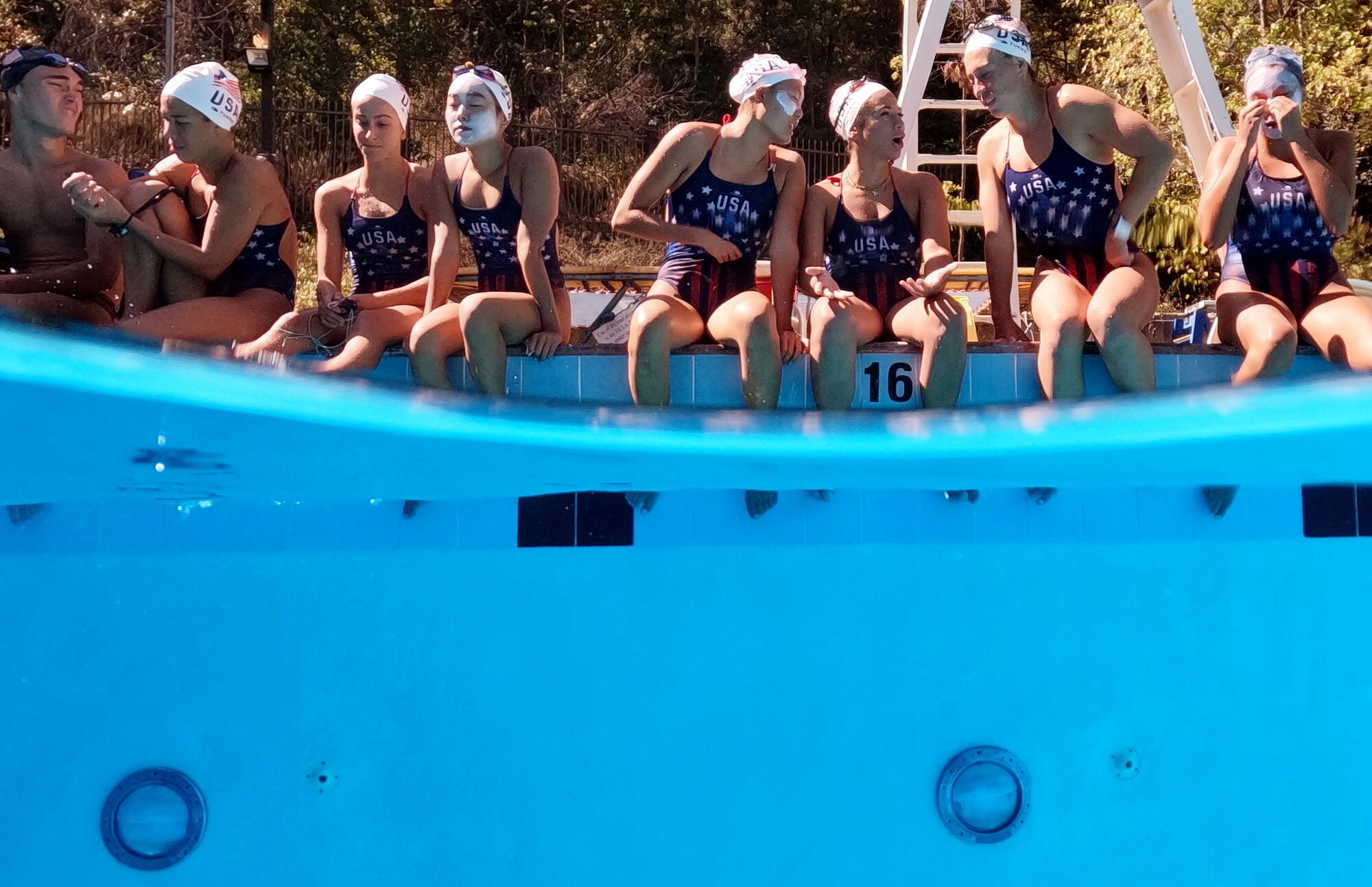 The U.S. Artistic Swimming team members talk poolside during a recent practice at UCLA.