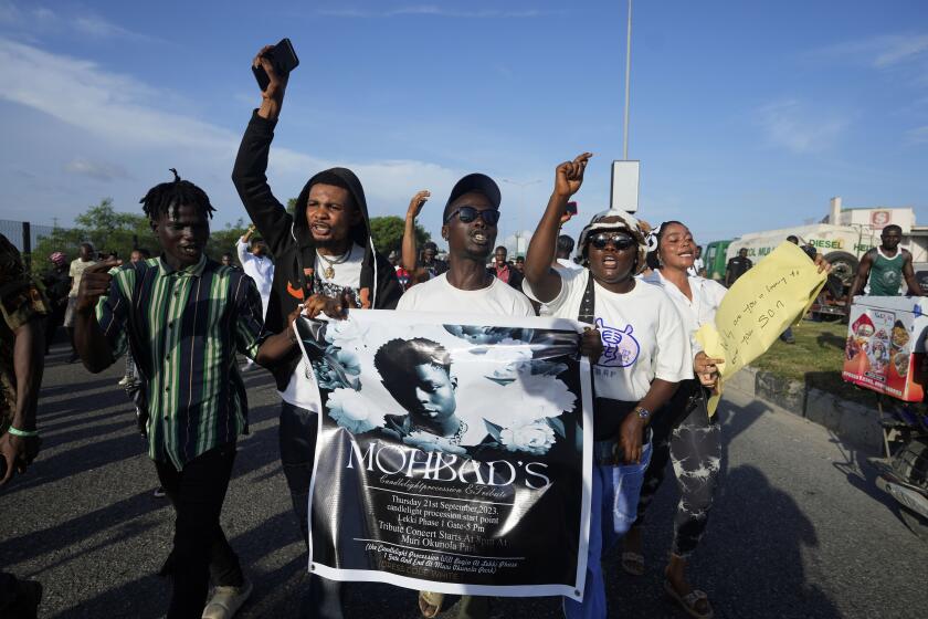 People chant slogans during a protest on the streets of Lagos, Nigeria, Thursday, Sept. 21, 2023, to demand justice following the mysterious death of Afrobeat star Mohbad. Lagos police said the body of the late Ilerioluwa Aloba, better known as MohBad, was exhumed Thursday afternoon in response to complaints about the unclear circumstances surrounding his death. (AP Photo/Sunday Alamba)