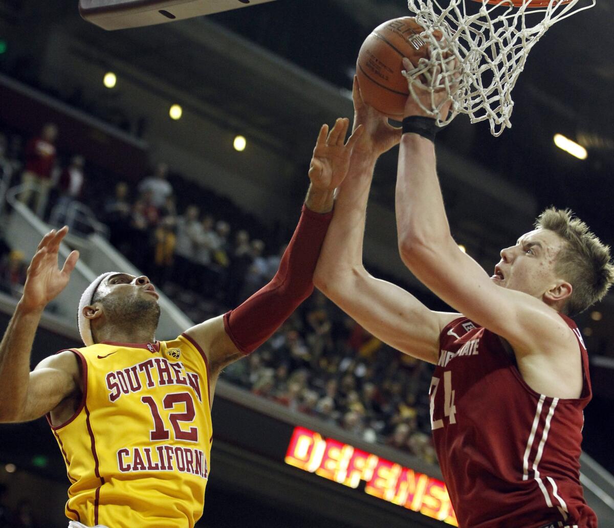 Washington State forward Josh Hawkinson, right, battles USC guard Julian Jacobs (12) for a rebound during the first half.