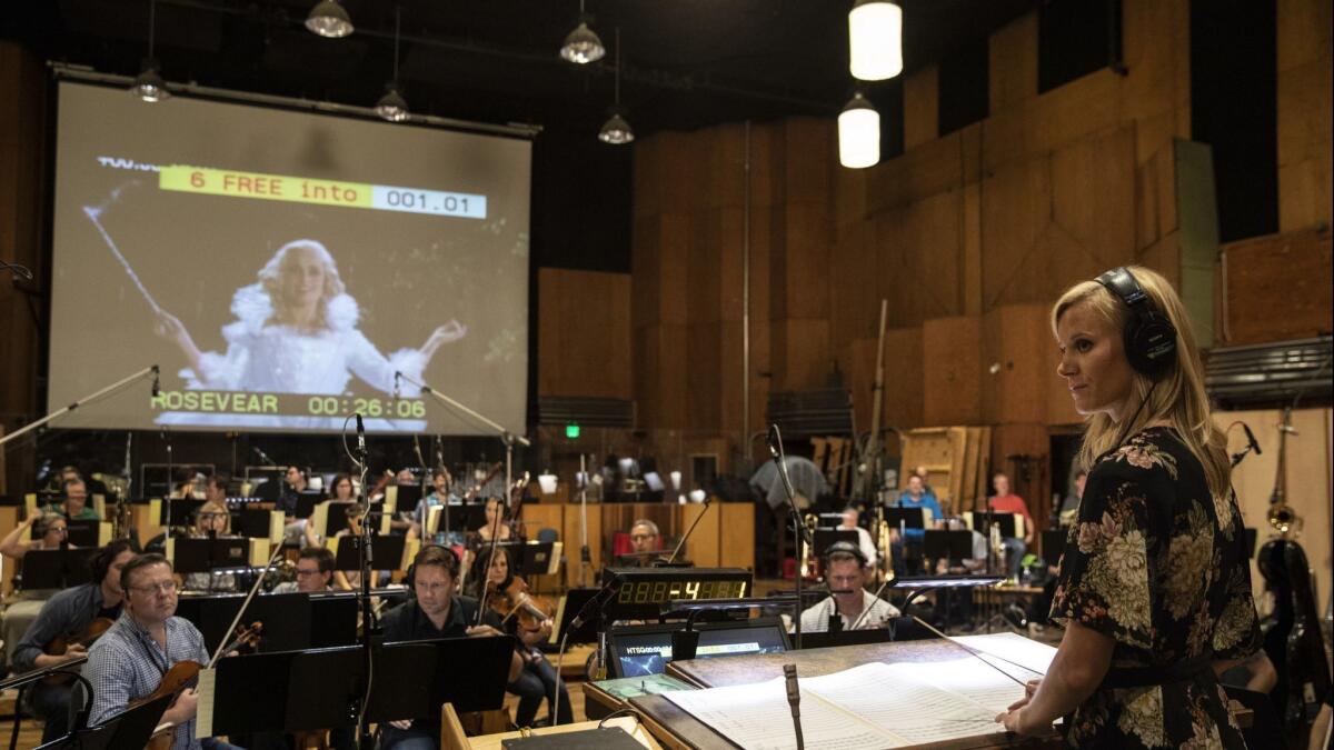 Annie Rosevear takes the podium to conduct a 64-piece orchestra with her original score for a clip from "Cinderella," at the culmination of the American Society of Composers, Authors and Publishers Film Scoring Workshop on the Newman Scoring Stage at FOX Studios.