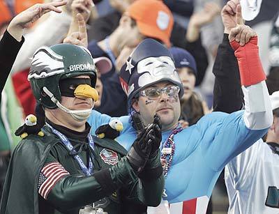 A Philadelphia Eagles fan and New England Patriots fan react during the pre-game festivities.