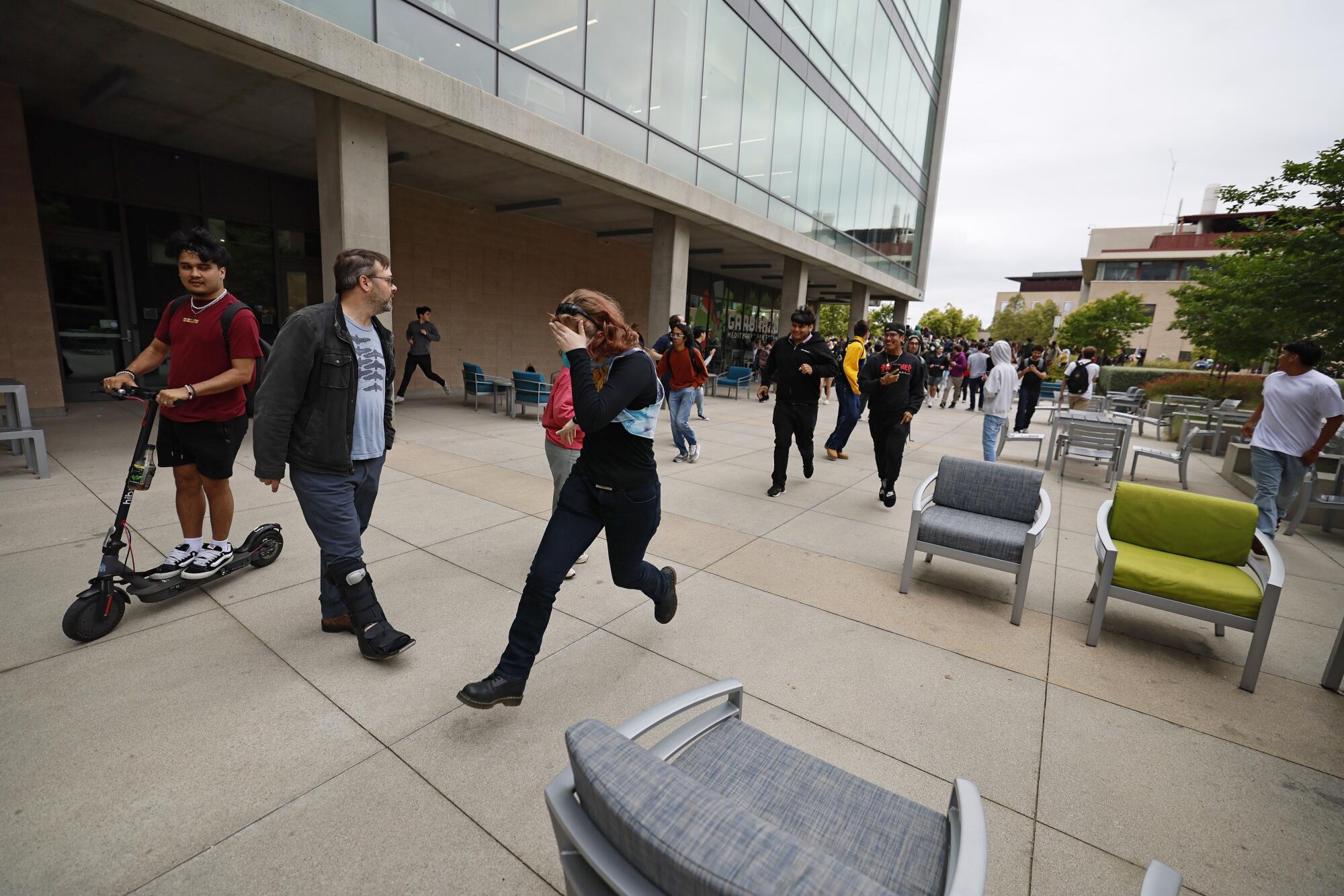 People flee the area after a weeks-long pro-Palestine protest at UC Irvine demanding