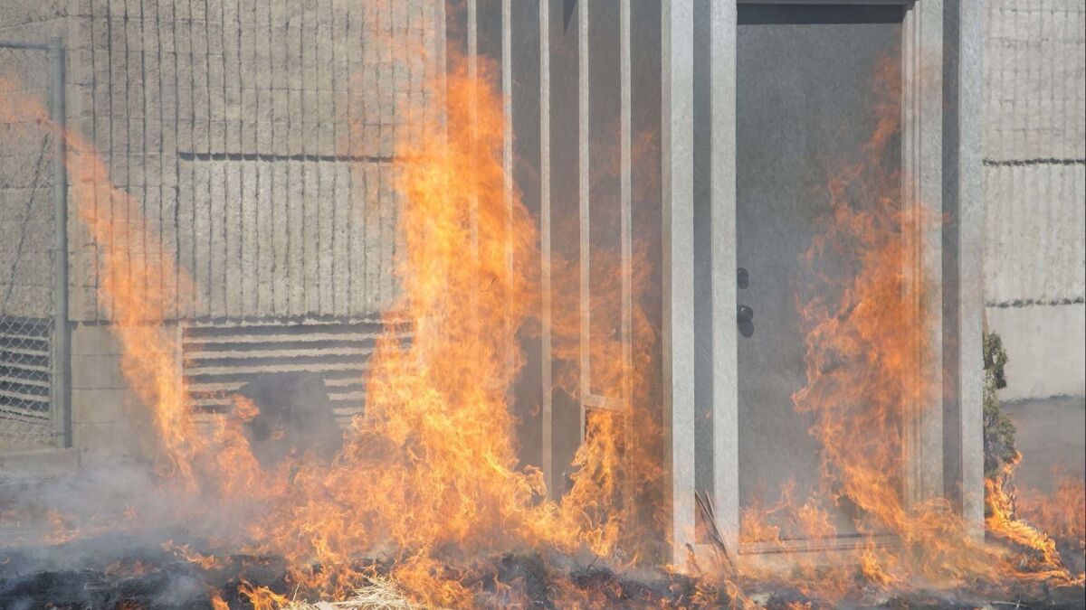 Combustibles were lit on fire around a shed to demonstrate it's resistance to wildfire. A demonstration was done Tuesday at the San Diego Fire-Rescue Training Center.