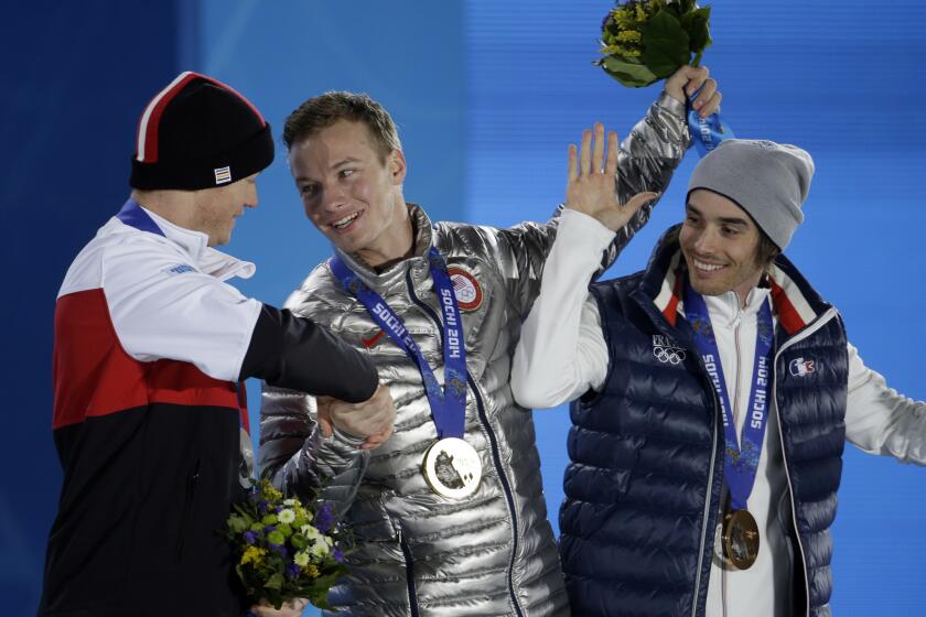 Men's freestyle skiing halfpipe medalists, from left, Mike Riddle of Canada (silver), David Wise of the United States (gold), and Kevin Rolland of France (bronze), congratulate one another during the medalceremony at the 2014 Winter Olympics in Sochi, Russia.