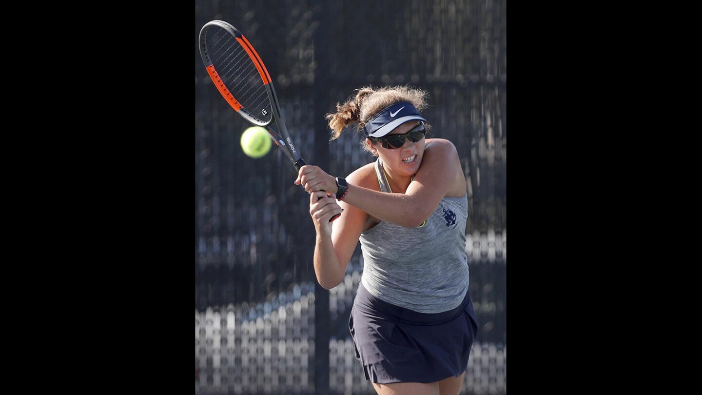 Newport Harbor High's Nicole Knickerbocker follows through with a backhand during a No.1 singles match against Fountain Valley in Newport Beach on Tuesday, Oct. 3.