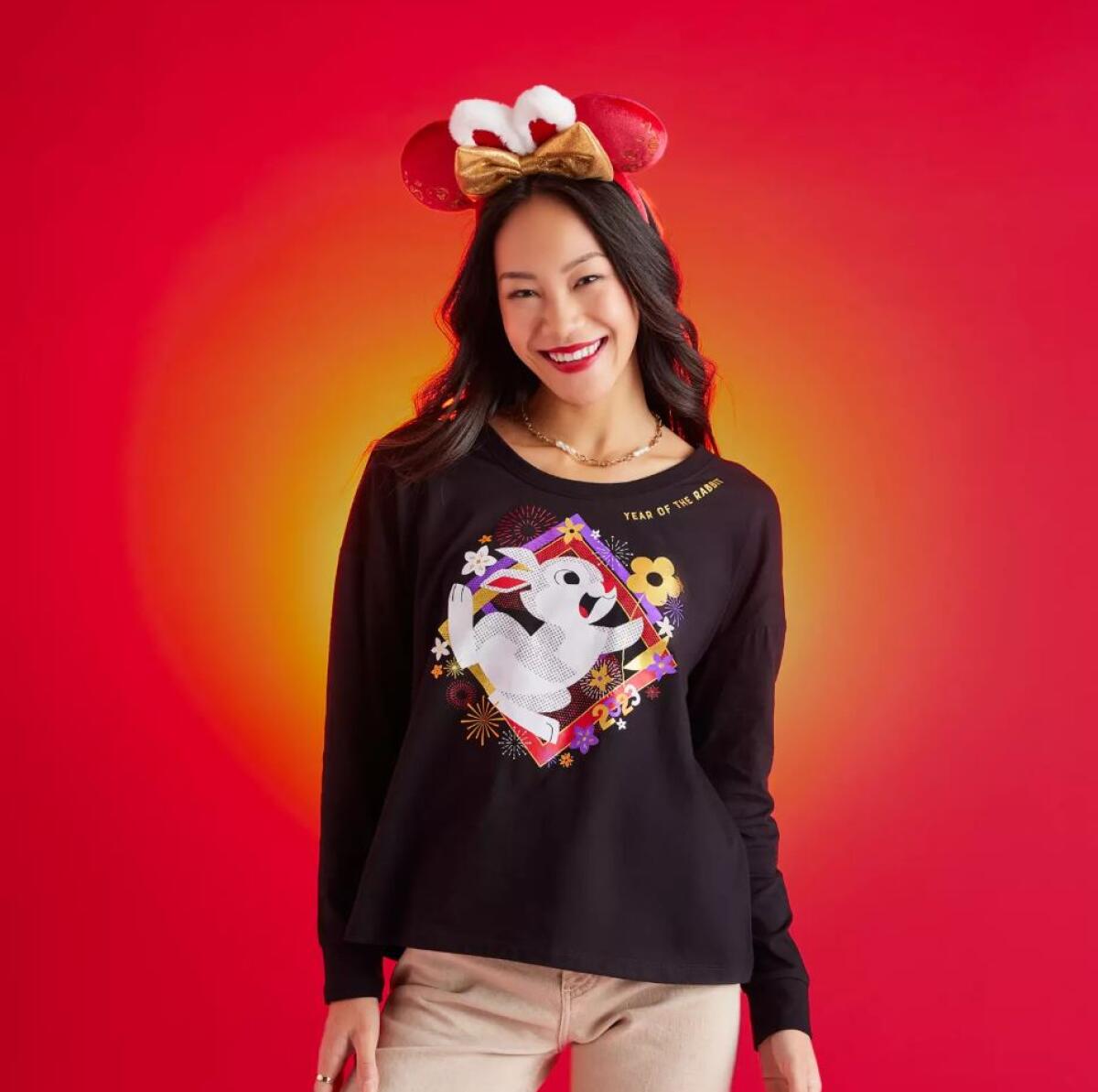 A woman wears a long-sleeve T-shirt with Thumper the rabbit and flowers on it.
