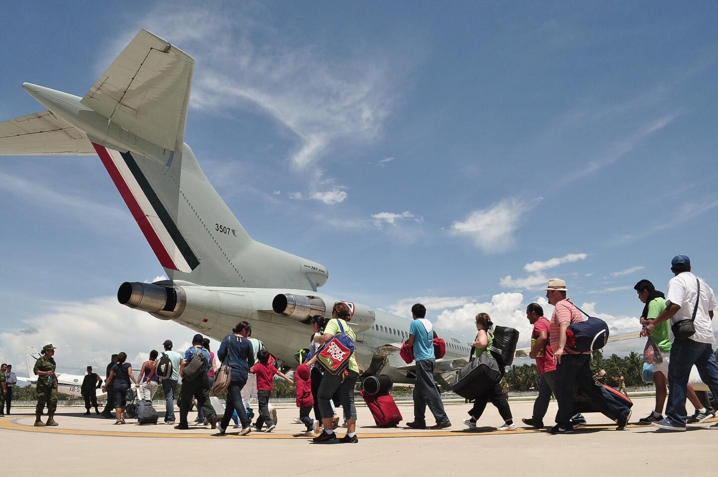 Tourists board a Mexican air force plane