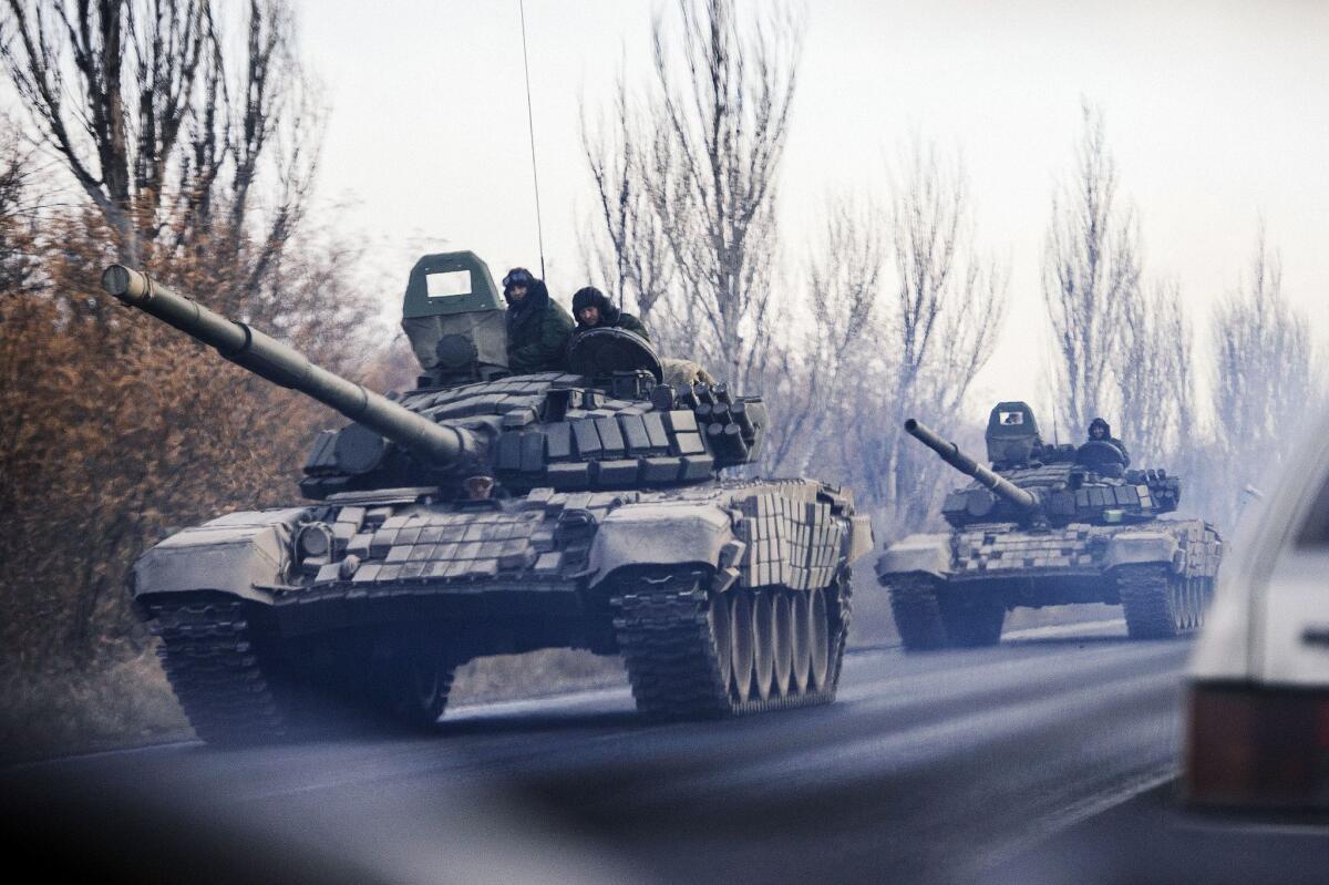 A column of tanks moves westward near the eastern Ukraine town of Shakhtarsk on Monday, part of a new influx of weapons and fighters seen by monitors of the Organization for Security and Cooperation in Europe.