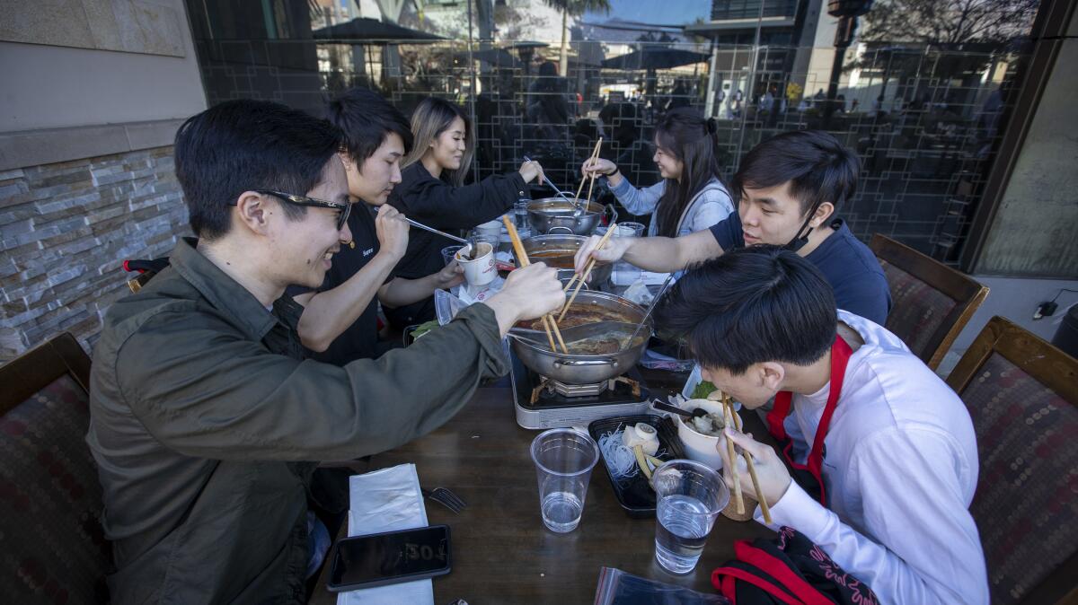 Diners have a meal outdoors at a restaurant