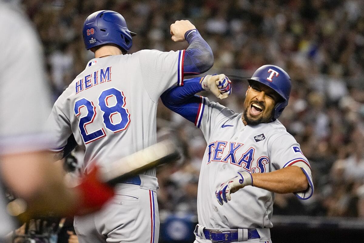 Texas Rangers' Marcus Semien celebrates his three-run home run with Jonah Heim.